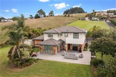 GORGEOUS HOME SURROUNDED BY LUSH LAWNS AND TROPICAL GARDENS