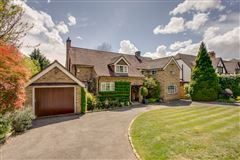 THIS FINE HOME SITS WELL WITHIN BEAUTIFULLY LANDSCAPED MATURE GARDENS