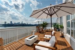 THIS GORGEOUS CORNER PENTHOUSE BOASTS A PRIVATE OVER-SIZED ROOF DECK