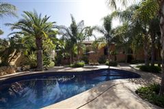 INVITING PROPERTY SURROUNDED BY LUSH GARDENS