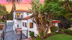 THIS BEAUTIFUL SPACIOUS HOME IS SET ON A PICTURESQUE STREET AT THE BASE OF THE HOLLYWOOD HILLS