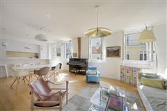 ELEGANT APARTMENT ENJOYING A VIEW OF LES INVALIDES WAS RENOVATED BY A RENOWNED INTERIOR DECORATOR