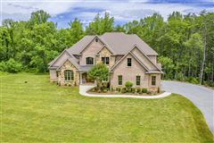 CUSTOM-BUILT BRICK AND STONE ESTATE HOME IN A PEACEFUL SETTING