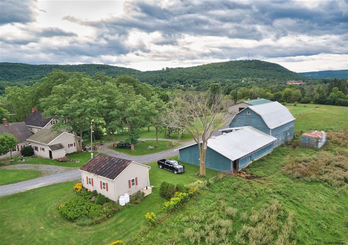 HISTORIC FARMHOUSE ON A PEACEFUL KNOLL OVERLOOKING 52 PRISTINE ACRES