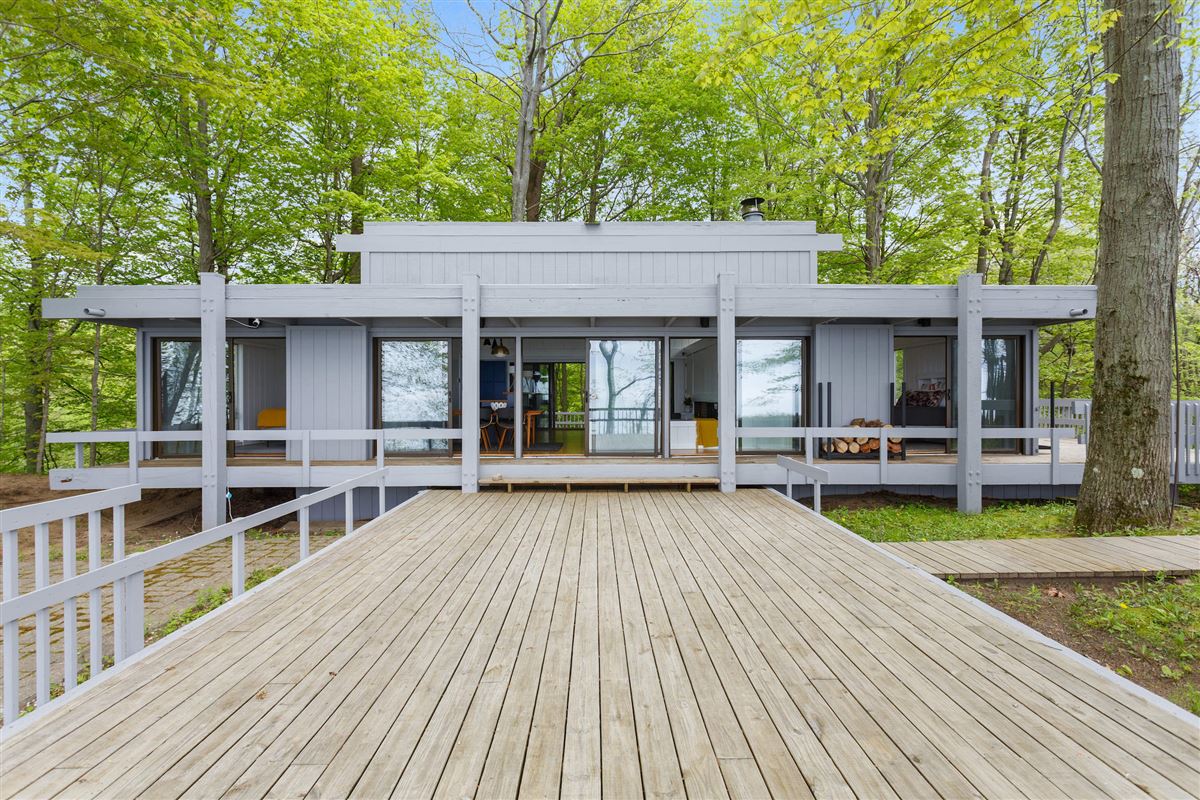 THIS NORMAN CARVER DESIGNED HOME HAS SWEEPING LAKE VIEWS FROM EVERY